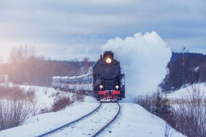 In Winter : A steam train moving with snow on the surroundings